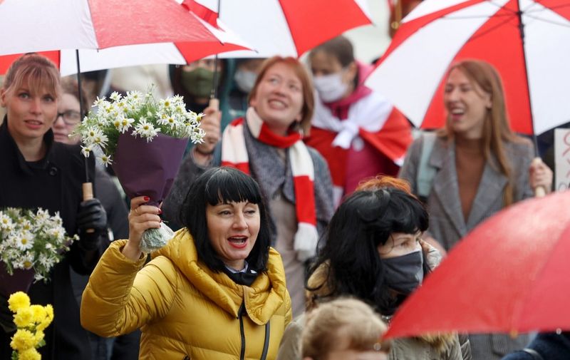 Women chant slogans as they take part in a women march to protest against Belarus' Presidential election results and police violence during a traditional Women's March in Minsk, on October 24, 2020. (Photo by Stringer / AFP)