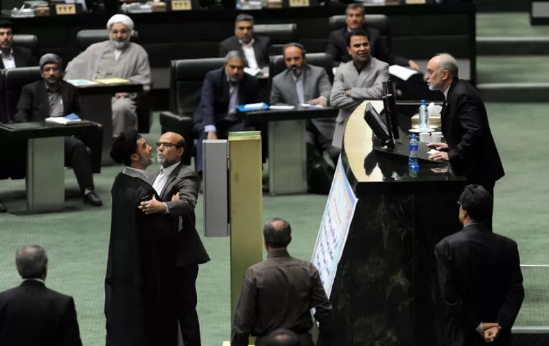 Iran's head of Atomic Energy Organisation (IAEO) Ali Akbar Salehi (R) argues with a member of parliament during a session in Tehran on October 11, 2015. Iran's parliament gave a partial nod to a nuclear deal with world powers Sunday but only after fiery clashes and allegations from a top negotiator that a lawmaker had threatened to kill him. AFP PHOTO / ISNA / AMIN KHOROSHAHI