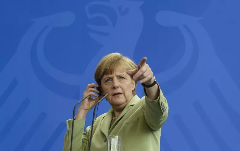 (FILES) - Picture taken on June 18, 2014 shows German Chancellor Angela Merkel gesturing during a joint press conference with Tunisian Prime Minister Mehdi Jomaa (not pictured) following talks at the chancellery in Berlin. Merkel and Jomaa meet for bilateral talks. German Chancellor Angela Merkel marks a decade in power on November 22, 2015 facing the fight of her life to defend her liberal stance on refugees against a party revolt and fresh fears sparked by the Paris carnage. AFP PHOTO / CLEMENS BILAN

TO GO WITH AFP STORIES MARKING GERMAN CHANCELLOR ANGELA MERKEL'S 10 YEARS IN POWER