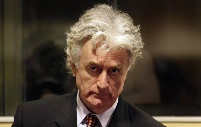 Bosnian Serb wartime leader Radovan Karadzic sits in the UN's Yugoslav warcrimes court in The Hague on August 29, 2008 for his second appearance before the court which is trying him for genocide, war crimes and crimes against humanity. Karadzic, 63, was arrested in Belgrade six weeks ago, 13 years after the International Criminal Tribunal for the former Yugoslavia issued an indictment against him over a campaign of "ethnic cleansing" during the 1992-95 Bosnian war in which 100,000 people died. AFP PHOTO / ANP PHOTO VALERIE KUYPERS netherlands out - belgium out / AFP / ANP / VALERIE KUYPERS