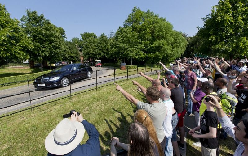 Protesters shout as a vehicle arrives at the drive to the venue where it is thought the 61st annual Bilderberg Meetings is taking place in Watford, north of London, on June 6, 2013. The Bilderberg Meetings aims to bring together over a hundred political leaders and experts from industry, finance, the media and the academy to take part in the annual conference. The conference provides a forum for off-the-record discussions about the trends and major issues facing the world, according to the Bilderberg website. Scores of demonstrators turned out to protest what they call the conferences lack of transparency.   AFP PHOTO / JUSTIN TALLIS