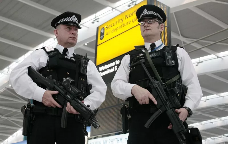 British armed police patrol the new Terminal 5 building at London's Heathrow Airport in west London, on March 14, 2008. Queen Elizabeth II unveiled a new terminal at London's main Heathrow airport Friday, under tight security a day after a major security scare disrupted flights. Terminal Five (T5) will be able to handle 30 million passengers a year, and opens as campaigners step up protests over plans for a third runway at the airport. It was unclear if Thursday's alert, in which a man scaled a perimeter fence and ran on to a runway, was designed as a protest. Police carried out a controlled explosion of two bags dropped by the man. AFP PHOTO/SHAUN CURRY (Photo by SHAUN CURRY / AFP)