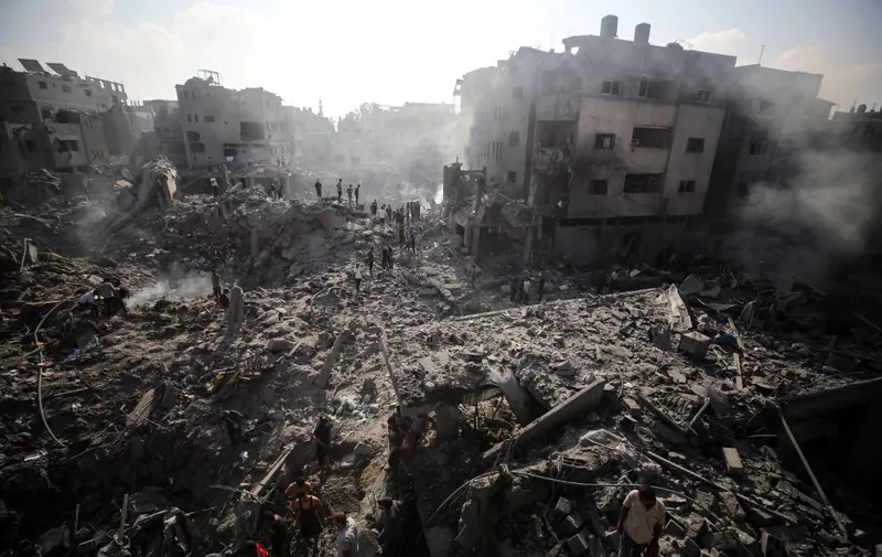 People check buildings destroyed in an Israeli strike on the Bureij refugee camp in the central Gaza Strip on November 2, 2023, as battles between Israel and the Palestinian Hamas movement continue.  (Photo by Majdi Fathi/NurPhoto) (Photo by MAJDI FATHI / NurPhoto / NurPhoto via AFP)