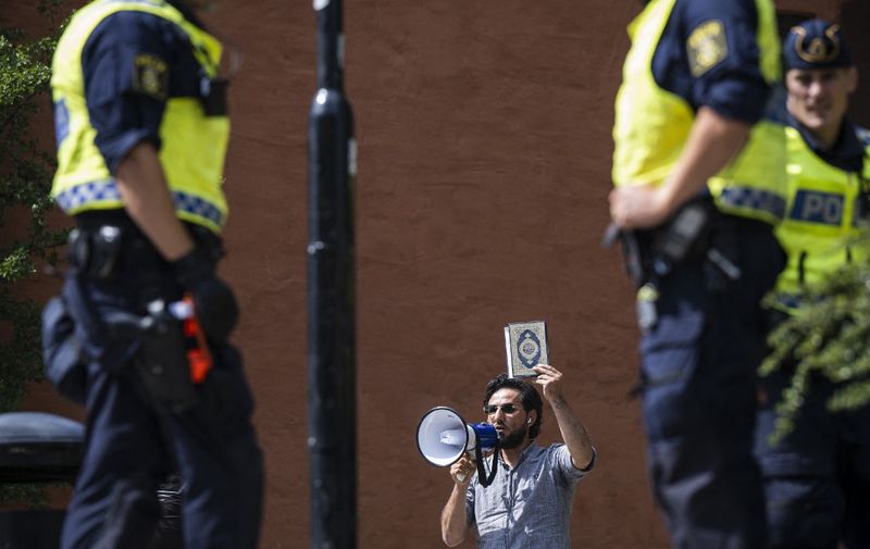 Salwan Momika protests outside a mosque in Stockholm on June 28, 2023, during the Eid al-Adha holiday. Momika, 37, who fled from Iraq to Sweden several years ago, was granted permission by the Swedish police to burn the Muslim holy book during the demonstration. (Photo by Jonathan NACKSTRAND / AFP)