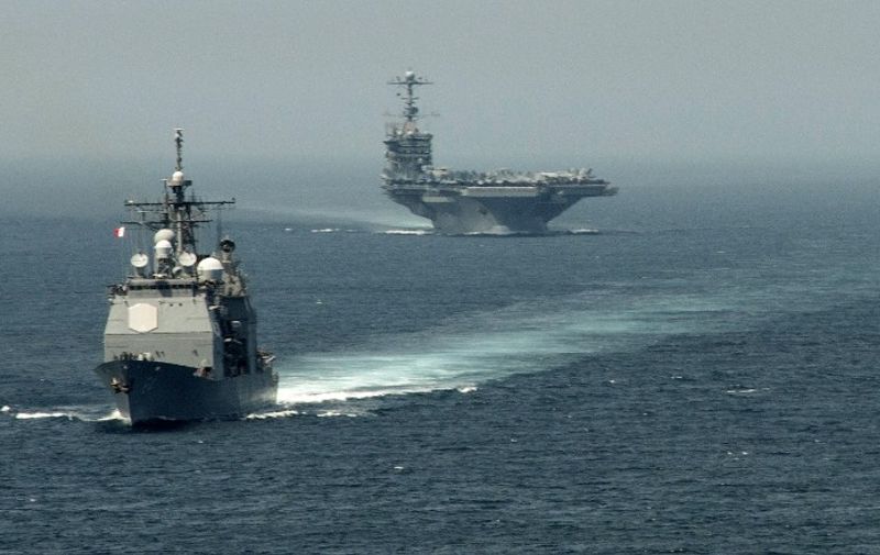 A picture released by the US Navy shows the guided-missile cruiser USS Gettysburg (CG 64) (L) and the aircraft carrier USS Harry S. Truman (CVN 75) transiting the Strait of Gibraltar on August 3, 2013 on their way to the Mediterranean Sea. US forces are "ready to go" if called on to strike the Syrian regime, Defense Secretary Chuck Hagel told the BBC on August 27, 2013, saying evidence pointed to its use of chemical weapons. The Pentagon chief said forces had been deployed as needed and President Barack Obama had reviewed military options presented by commanders. AFP PHOTO/US NAVY - Jamie Cosby
=== RESTRICTED TO EDITORIAL USE - MANDATORY CREDIT "AFP PHOTO / US NAVY / Jamie Cosby" - NO MARKETING NO ADVERTISING CAMPAIGNS - DISTRIBUTED AS A SERVICE TO CLIENTS ==== / AFP / US NAVY FILE / Jamie Cosby