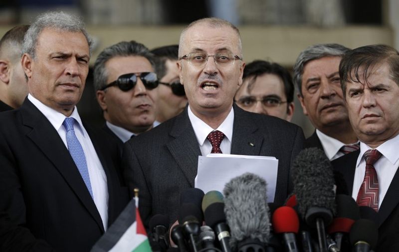 Palestinian prime minister Rami Hamdallah speaks during a press conference in Gaza City on March 25, 2015 during a visit in the Palestinian coastal territory. Hamdallah urged rival factions to set aside their differences, even as protesters gave him a cool reception in war-battered Gaza . AFP PHOTO / MOHAMMED ABED