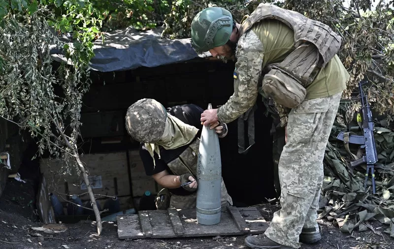 Ukrainian artillerymen prepare 152 mm projectiles for artillery at a position on the front line near Bakhmut, eastern Ukraine, on July 20, 2023, amid the Russian invasion of Ukraine. (Photo by Genya SAVILOV / AFP)