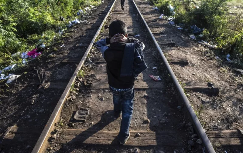 TOPSHOTS
A child walks along a railway track at the Hungary-Serbia border, near the town of Horgos, on September 14, 2015. Germany said it was reinstating border controls on September 13, as Europes top economy admitted it could no longer cope with a record influx of refugees. AFP PHOTO / ARMEND NIMANI