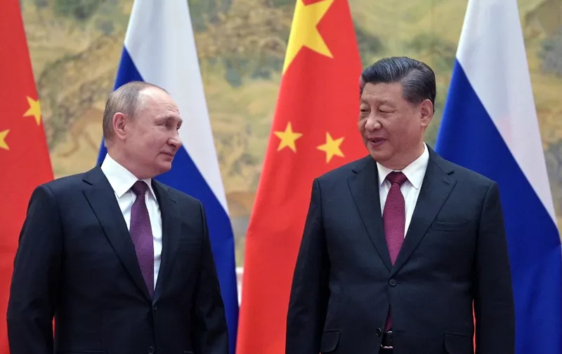 Russian President Vladimir Putin (L) and Chinese President Xi Jinping pose for a photograph during their meeting in Beijing, on February 4, 2022. (Photo by Alexei Druzhinin / Sputnik / AFP)