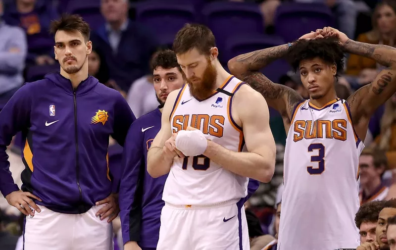 PHOENIX, ARIZONA - JANUARY 07: (L-R)  Dario Saric #20, Jalen Lecque #0, Aron Baynes #46 and Kelly Oubre Jr. #3 of the Phoenix Suns react on the bench during the second half the NBA game against the Sacramento Kings at Talking Stick Resort Arena on January 07, 2020 in Phoenix, Arizona.  The Kings defeated the Suns 114-103. NOTE TO USER: User expressly acknowledges and agrees that, by downloading and or using this photograph, user is consenting to the terms and conditions of the Getty Images License Agreement. (Photo by Christian Petersen/Getty Images)