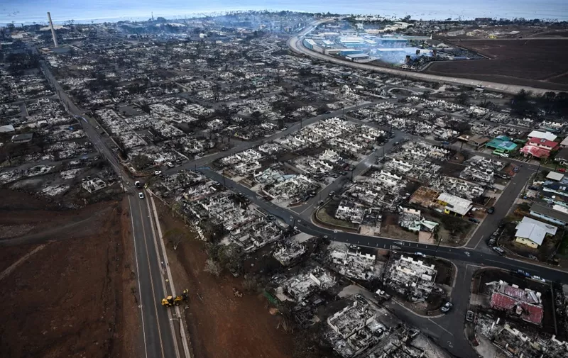 An aerial image taken on August 10, 2023 shows destroyed homes and buildings burned to the ground in Lahaina in the aftermath of wildfires in western Maui, Hawaii. At least 36 people have died after a fast-moving wildfire turned Lahaina to ashes, officials said August 9, 2023 as visitors asked to leave the island of Maui found themselves stranded at the airport. The fires began burning early August 8, scorching thousands of acres and putting homes, businesses and 35,000 lives at risk on Maui, the Hawaii Emergency Management Agency said in a statement. (Photo by Patrick T. Fallon / AFP)