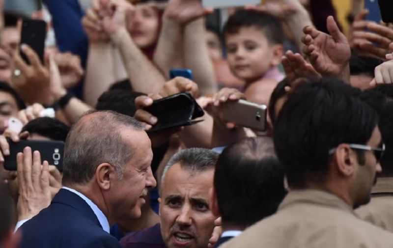 Turkish President and leader of the Justice and Development Party (AKP) Recep Tayyip Erdogan (L) leaves after casting his ballot at a polling station during snap twin Turkish presidential and parliamentary elections in Istanbul on June 24, 2018.
Turks began voting in dual parliamentary and presidential polls seen as the President's toughest election test, with the opposition revitalised and his popularity at risk from growing economic troubles. / AFP PHOTO / ARIS MESSINIS