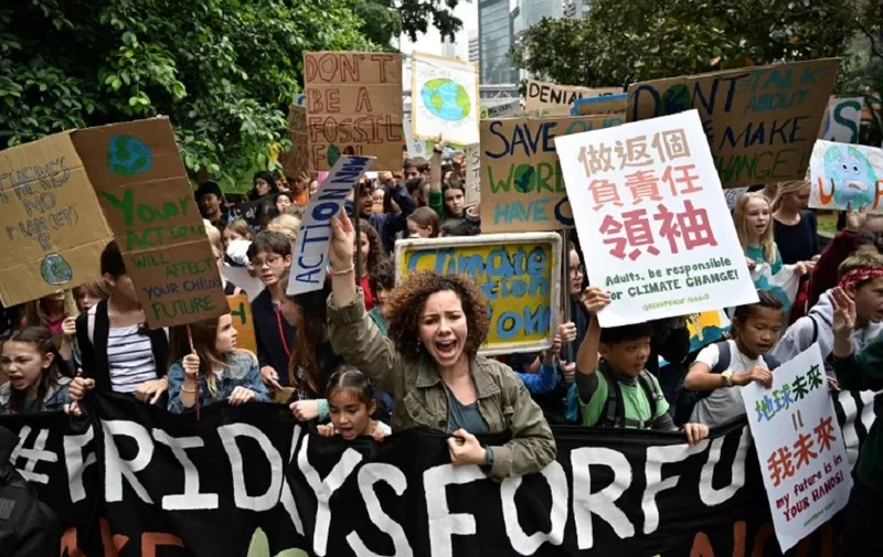 Students take part in a protest against climate change in Hong Kong on March 15, 2019, as part of a global movement called #FridaysForFuture. - Thousands of young people marched through cities in Asia on March 15, kicking off a global day of student protests that aims to spark world leaders into action on climate change. (Photo by Anthony WALLACE / AFP)