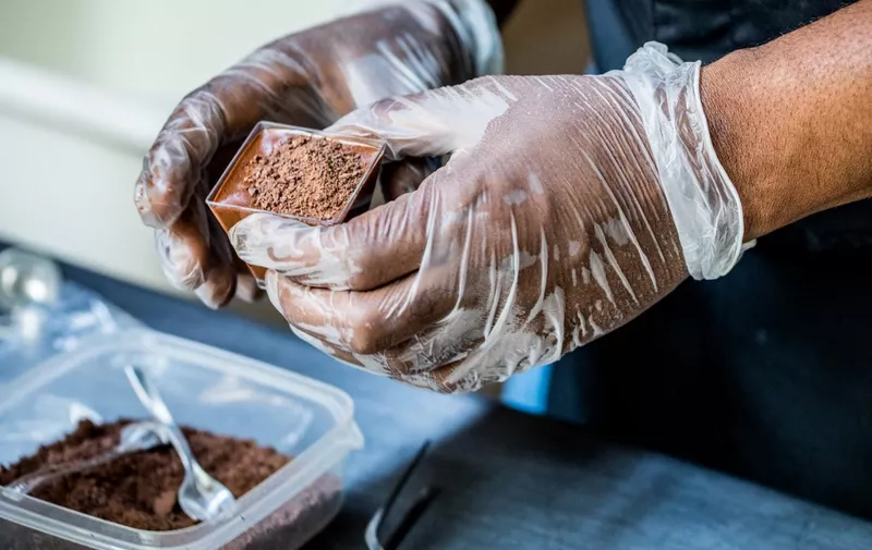 Preparation of a chocolate mousse by chocolate maker Ralph Leroy in the workshops of Makaya Chocolat on December 23, 2020 in Petionville, Haiti. Although small in the face of South America's giants, Haiti is slowly developing its cocoa industry to ensure better incomes for thousands of modest farmers and to end the stereotype of gastronomic art known as the domain of wealthy countries. (Photo by Valerie Baeriswyl / AFP)