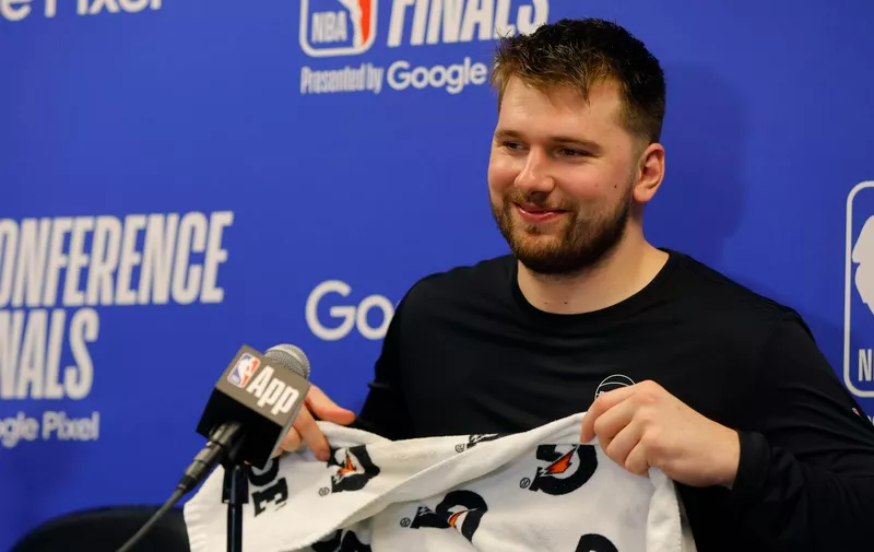 Dallas Mavericks guard Luka Doncic (77) smiles during a news conference after Game 2 of the NBA basketball Western Conference finals, Friday, May 24, 2024, in Minneapolis. (AP Photo/Bruce Kluckhohn)