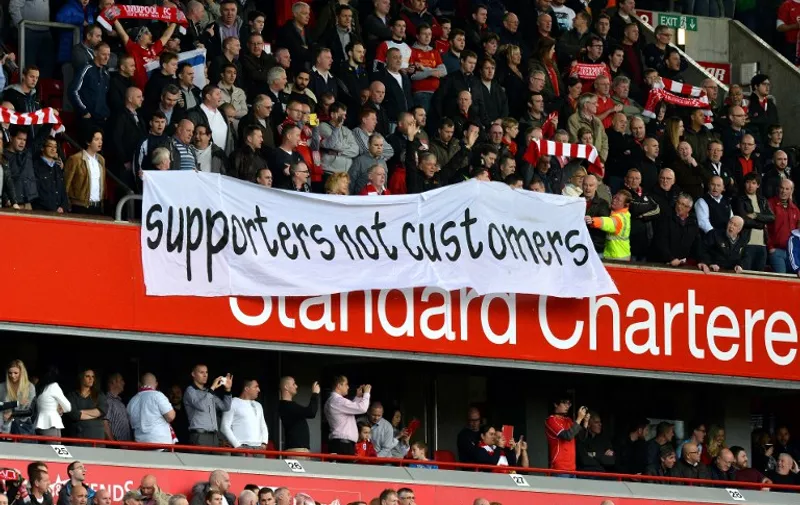 Liverpool supporters protest about ticket prices during the English Premier League football match between Liverpool and Hull City at the Anfield stadium in Liverpool, northwest England, on October 25, 2014. The match ended 0-0.  

RESTRICTED TO EDITORIAL USE. No use with unauthorized audio, video, data, fixture lists, club/league logos or live services. Online in-match use limited to 45 images, no video emulation. No use in betting, games or single club/league/player publications.