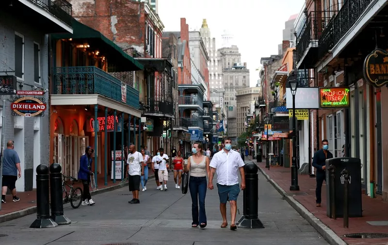 NEW ORLEANS, LOUISIANA - JULY 14: Pedestrians are seen walking along Bourbon Street in the French Quarter on July 14, 2020 in New Orleans, Louisiana. Louisiana Gov. John Bel Edwards issued three new restrictions for Phase II of reopening that will be in place until at least until July 24 across Louisiana to help prevent the spread of COVID-19. Restrictions include mandatory mask or face covering outside of the home for those eight years old and older, bars will be closed unless providing curbside pickup, and indoor social gatherings are to be limited to 50 people.   Sean Gardner/Getty Images/AFP