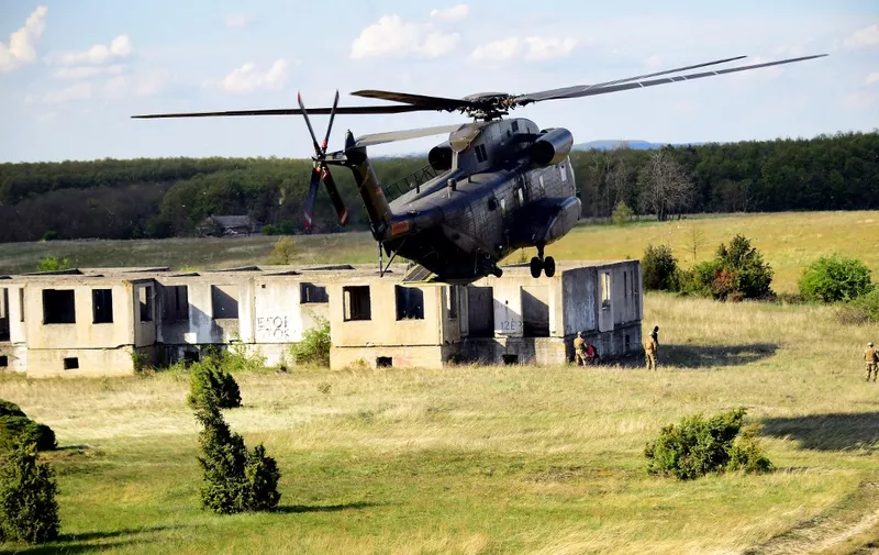 A German Air Force heavy-lift transport helicopter (Sikorsky) lands during an exercise at Papa Airbase, a military training center nearby Ujdoeroegd, Hungary, on May 4, 2017. - The exercise is part of the European Defence Agency's Helicopter Exercise Programme (HEP) that takes place from May 1-12, 2017, with around 500 personnel and 16 aircrafts from 5 member states. (Photo by ATTILA KISBENEDEK / AFP)