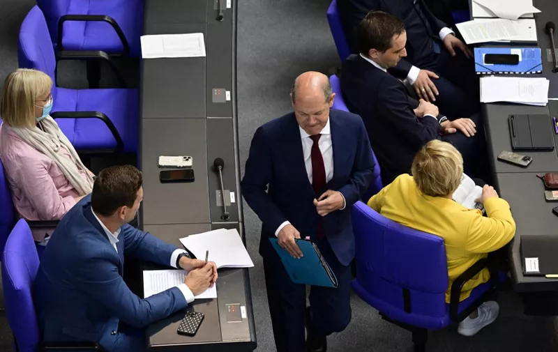 German Chancellor Olaf Scholz leaves after a session of questions at the Bundestag, the German lower house of parliament, in Berlin on July 6, 2022. (Photo by John MACDOUGALL / AFP)
