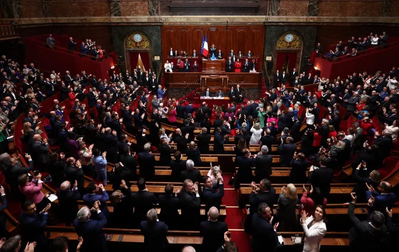 Mps and senators applaud after the French parliament voted to anchor the right to abortion in the country's constitution, in Versailles, on March 4, 2024, making France the first country in the world to offer explicit protection for terminating a pregnancy in its basic law. (Photo by EMMANUEL DUNAND / AFP)
