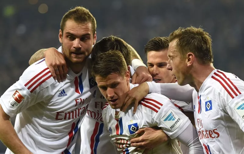 Hamburg's Croatian midfielder Ivo Ilicevic is congratulated by team members after scoring during the German first and second Bundesliga relegation football match Hamburger SV vs Karlsruher SC in Hamburg, northern Germany, on May 28, 2015. AFP PHOTO / TOBIAS SCHWARZ / AFP / TOBIAS SCHWARZ