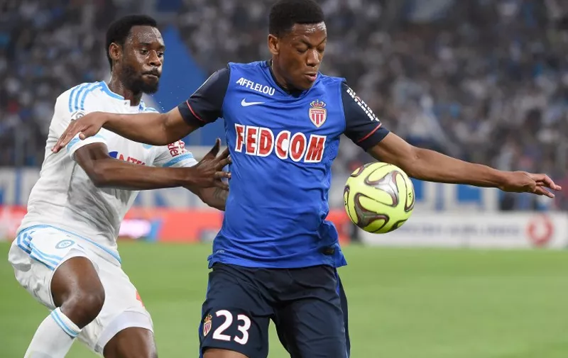 Marseille's Cameroonian defender Nicolas Nkoulou (L) vies with Monaco's French forward Anthony Martial (R) during the French L1 football match between Marseille and Monaco on May 10, 2015 at the Velodrome stadium in Marseille, southeastern France. AFP PHOTO / BORIS HORVAT