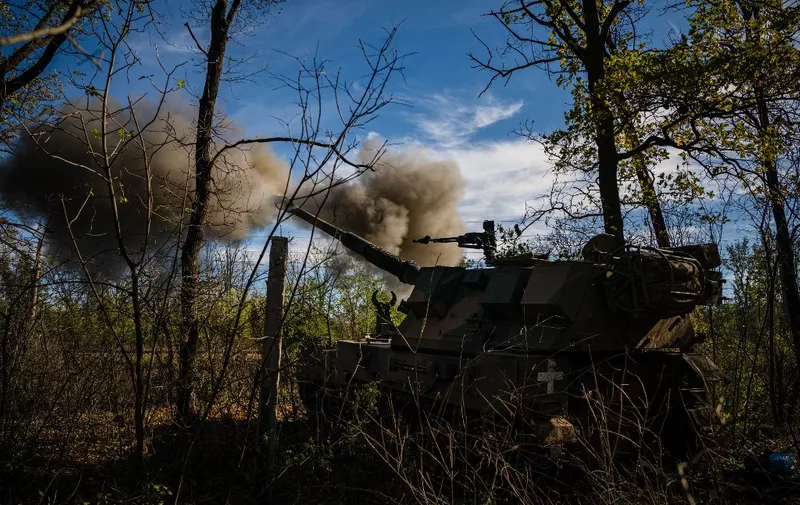 Ukrainian servicemen fire a Polish 155mm self-propelled tracked gun-howitzer Krab from a position on the front line in the Donetsk region on October 19, 2022, amid Russian invasion of Ukraine. (Photo by Dimitar DILKOFF / AFP)