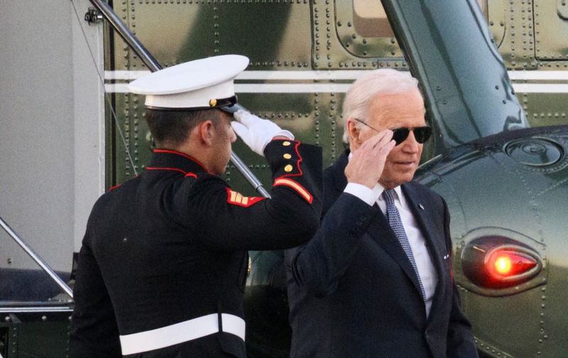 US President Joe Biden salutes as he steps off Marine One upon arrival at Gordons Pond in Cape Henlopen State Park in Lewes, Delaware on October 21, 2022. - Biden is heading to his beach house in Rehoboth Beach, Delaware to spend the weekend. (Photo by Mandel NGAN / AFP)