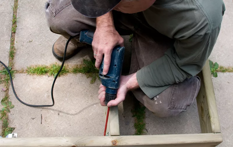 handyman using a drill in the construction of a deck,Image: 89447027, License: Royalty-free, Restrictions: , Model Release: yes