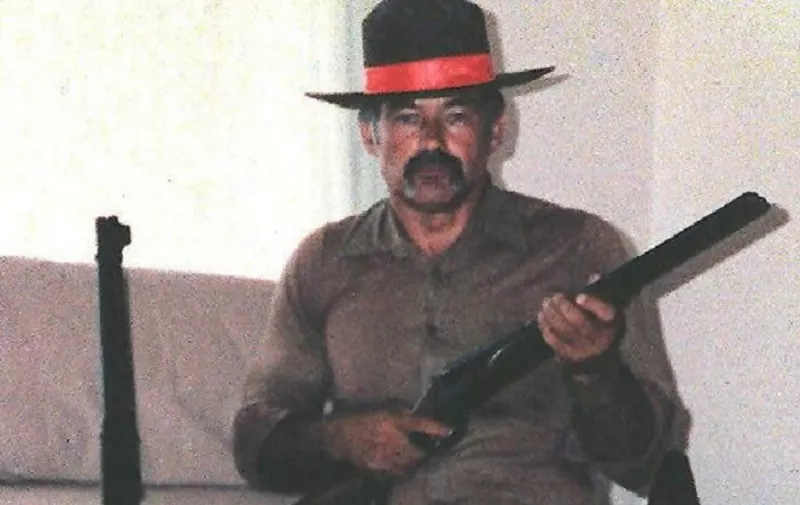 Ivan Milat, who was sentenced to life imprisonment last July for the murders of seven backpackers, is shown in an undated photograph with a rifle and pistol and a favourite cowboy hat. Milat had been planning a jailbreak when his accomplice, drug baron George Savvas was found hanged in a cell at Sydney's Maitland prison 18 May, apparently depressed at the failure of the breakout. After foiling the escape plan, and following Savvas' suicide, Milat was moved to the maximum-security Long Bay jail.