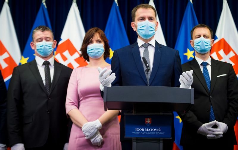 Newly appointed Slovak Prime Minister Igor Matovic, leader of the OLaNO anti-graft party and his ministers of the new government attend a press conference after first meeting of new government in Office of Government in Bratislava on March 21, 2020. - Face masks and gloves were mandatory attire as Slovakia's president swore-in the EU country's new government in Bratislava amid the COVID-19 pandemic. (Photo by VLADIMIR SIMICEK / AFP)
