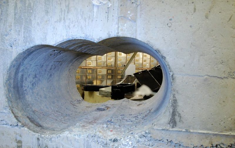 A handout photo received from the British Metropolitan Police Service in London on April, 22, 2015, shows holes bored through a half-meter thick concrete wall drilled to access a vault in a safe deposit centre in Hatton Garden, London, where an estimated £200 million worth of diamonds and jewellery were stolen between April 2 and [&hellip;]