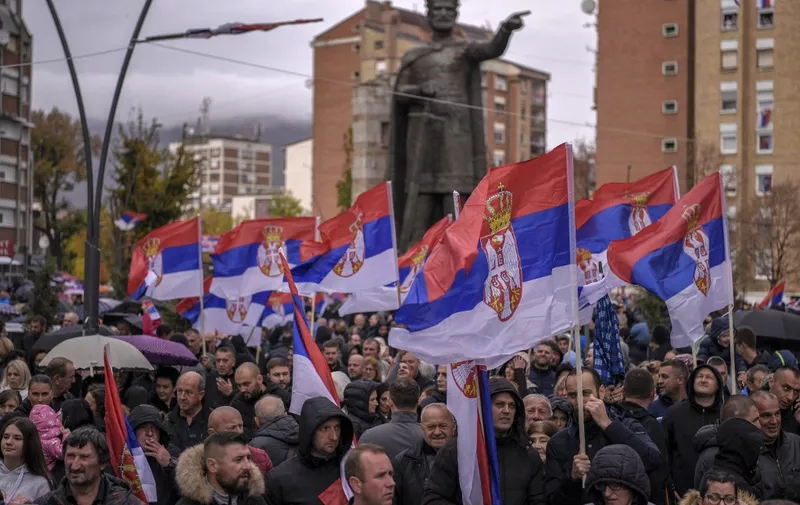Kosovo Serbs wave Serbian flags during a protest in the Serb predominant part of Mitrovica on November 6, 2022. - Serbs in northern Kosovo said they are quitting jobs at state institutions such as police and judiciary to protest against a government which orders that all citizens must use car license plates issued by Kosovo authorities. (Photo by Armend NIMANI / AFP)