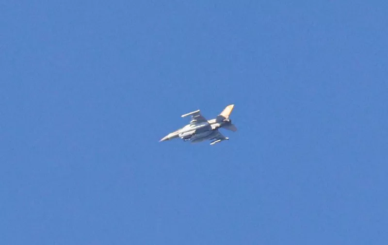 A picture taken from southern Israel near the border with the Gaza Strip on December 2, 2023, shows an Israeli fighter jet flying over the Palestinian territory during Israeli bombardment amid continuing battles between Israel and the militant group Hamas. Israel carried out deadly bombardments in Gaza for a second day on December 2 after a week-long truce with Hamas collapsed despite international calls for an extension. (Photo by JACK GUEZ / AFP)
