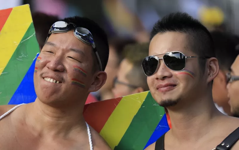 Participants pose at the square outside the presidential office before the start of a gay pride parade in Taipei on October 27, 2018. - Flamboyant drag queens and horned devils rubbed shoulders with Christian pastors and supporters on October 17 as tens of thousands of people took part in Taipei's Gay Pride parade -- the biggest in Asia -- ahead of a landmark vote next month on LGBT rights on the island. (Photo by Daniel Shih / AFP)