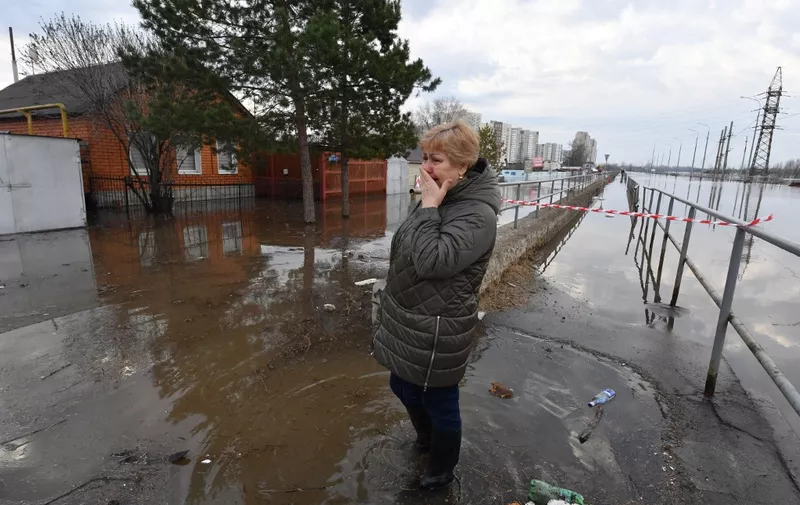Lyudmila Borodina, 56, medical worker, cries in a flooded residential area of the city of Orenburg on April 13, 2024. Flooding in the Russian city of Orenburg became "critical" on April 12, 2024 forcing "mass evacuations" as the Ural river level rises, the mayor said. Fast-rising temperatures have melted snow and ice, and along with heavy rains have caused a number of major rivers that cross Russia and Kazakhstan to overflow. (Photo by Olga MALTSEVA / AFP)