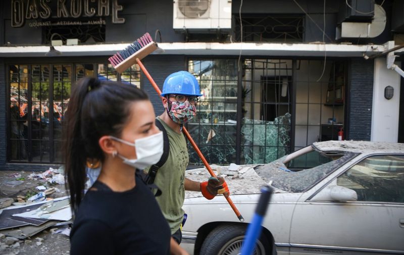 Lebanese activists take part in a campaign to clean the damaged neighbourhood of Mar Mikhael on August 5, 2020, a day after a blast in a warehouse in the port of the Lebanese capital sowed devastation across entire city neighbourhoods, killing more than 100 people, wounding thousands and plunging Lebanon deeper into crisis. - Rescuers searched for survivors in Beirut in the morning after a cataclysmic explosion at the port sowed devastation across entire neighbourhoods, killing more than 100 people, wounding thousands and plunging Lebanon deeper into crisis. (Photo by PATRICK BAZ / AFP)