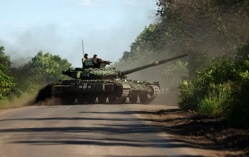 Ukrainian servicemen drive a tank on a road near the front line in the Donetsk region on June 5, 2023, amid the Russian invasion of Ukraine. (Photo by Anatolii STEPANOV / AFP)