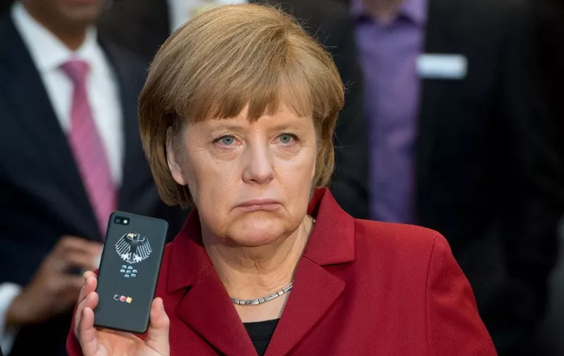 (FILES) - Picture taken on March 5, 2013 shows German Chancellor Angela Merkel holding a BlackBerry mobile device at the stand of Secusmart as she tours the CeBIT high-tech fair during the opening event of the world's largest computer expo in Hanover, central Germany. Germany's chief prosecutor has dropped a probe into the alleged tapping of Chancellor Angela Merkel's mobile phone by US intelligence agencies, his office said on June 12, 2015. "The Chief Federal Prosecutor has closed the investigation over suspected spying on a mobile phone used by the chancellor by US intelligence services ... because the allegation cannot be proven in a legally sound way under criminal law," it said in a statement. 

AFP PHOTO / DPA  / JULIAN STRATENSCHULTE    GERMANY OUT