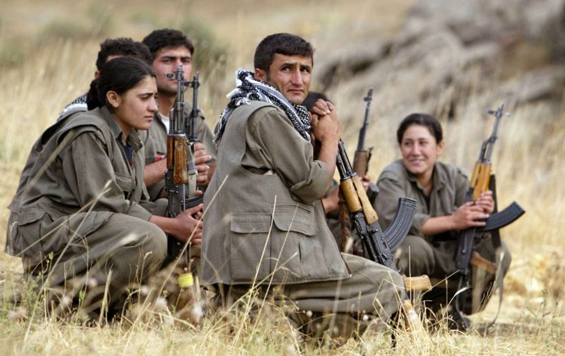 Guerrilla fighters of the PKK (Kurdistan Worker's Party) listen to instructions from their team commander during a training session in a camp near Arbil in the Haqourqi mountains, northern Iraq, 11 August 2005. The PKK, which has stepped up violence in Turkey's mainly Kurdish southeast over the past few months, retreated to northern Iraq after a unilateral ceasefire it declared in 1999 in its war with Ankara. The militants began sneaking back after they called off the truce in June 2004. The Kurdish conflict in Turkey has claimed some 37,000 lives since 1984 when the PKK took up arms for Kurdish self-rule in the country's southeast.       AFP PHOTO/Mustafa Ozer