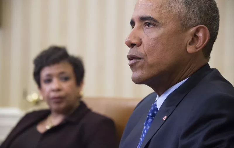 US President Barack Obama speaks with Attorney Genral Loretta Lynch in the Oval Office of the White House in Washington, DC, January 4, 2016.  President Barack Obama is poised to unveil a raft of executive actions to tackle US gun violence, kicking-off his last year in the White House with a show of political power. Frustrated at the unbending political opposition to gun control, despite the American scourge of mass shootings, Obama is now looking to bypass Congress with executive steps that aides say will focus on regulating gun sales and curbing illegal purchases. The proposals -- being presented to Obama by Attorney General Loretta Lynch at the White House Monday -- could tighten rules on gun dealers and crack down on "straw purchases" in which potentially suspect individuals buy guns through an intermediary. AFP PHOTO / JIM WATSON / AFP / JIM WATSON