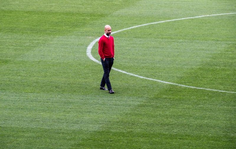 Pep Guardiola, coach of FC Bayern Munich, walking across the field of the stadium before the final press conference of FC Bayern Munich in Madrid, Germany, 26 April 2016. Bayern meets Atletico Madrid in the Champions League semifinals first leg match on 27 April 2016. PHOTO: PETER KNEFFEL/dpa