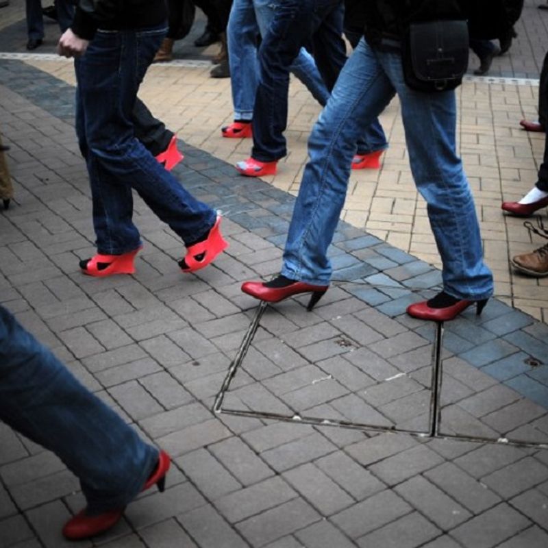 Bulgarian men wearing high heels walk during the second edition of Bulgaria's "Walk a Mile in Her Shoes", in Sofia, on March 8, 2014, as part of an international awareness campaign designed to raise awareness and stop rape, sexual assault and gender violence. AFP PHOTO / NIKOLAY DOYCHINOV / AFP PHOTO / NIKOLAY DOYCHINOV