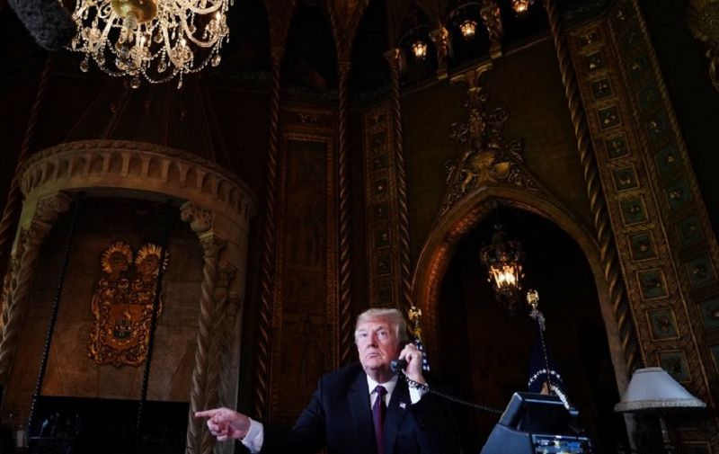 US President Donald Trump speaks to members of the military via teleconference from his Mar-a-Lago resort in Palm Beach, Florida, on Thanksgiving Day, November 22, 2018. (Photo by Mandel NGAN / AFP)