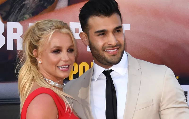 (FILES) US singer Britney Spears (L) and boyfriend Sam Asghari arrive for the premiere of Sony Pictures' "Once Upon a Time... in Hollywood" at the TCL Chinese Theatre in Hollywood, California on July 22, 2019. Spears and her model husband Asghari are heading for a divorce after 14 months of marriage, US media reported -- the latest personal crisis for the troubled pop star. Asghari, 29, filed divorce papers noting "irreconcilable differences" in their relationship, US entertainment media said on August 16, 2023, citing "multiple sources." The couple was married in 2022. (Photo by VALERIE MACON / AFP)