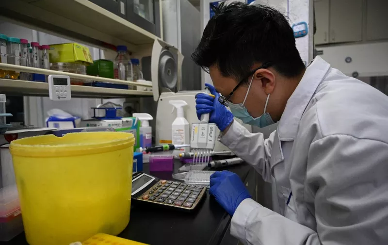 A laboratory technician works at a Tsinghua University lab in Beijing on December 9, 2021, which co-developed a monoclonal antibody treatment for Covid-19 with the Third People's Hospital of Shenzhen and Brii Biosciences and was granted emergency approval by China's drug authority on December 8. (Photo by Noel Celis / AFP)