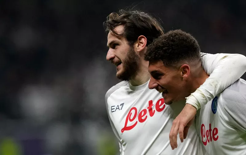 Napoli's Giovanni Di Lorenzo, right, celebrates with Napoli's Khvicha Kvaratskhelia after scoring his side's second goal during the Champions League round of 16 second leg soccer match between Eintracht Frankfurt and Napoli, at the Deutsche Bank Arena in Frankfurt, Germany, Tuesday, Feb. 21, 2023. (AP Photo/Michael Probst)