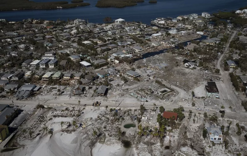 An aerial picture taken on September 30, 2022 shows destroyed houses and businesses in the aftermath of Hurricane Ian in Fort Myers Beach, Florida. Forecasters expect Hurricane Ian to cause life-threatening storm surges in the Carolinas on Friday after unleashing devastation in Florida, where it left a yet unknown number of dead in its wake. After weakening across Florida, Ian regained its Category 1 status in the Atlantic Ocean and was headed toward the Carolinas, the US National Hurricane Center said Friday. (Photo by Ricardo ARDUENGO / AFP)