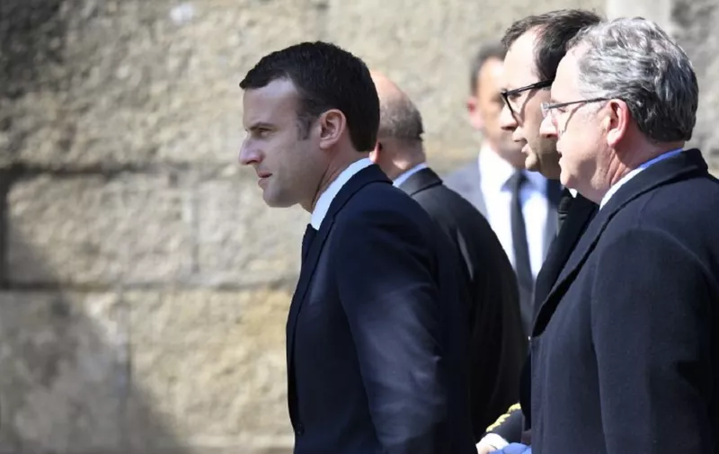 French president-elect Emmanuel Macron (L) arrives to attend the funeral ceremony of French socialist lawmaker Corinne Erhel, at the Saint-Jean-du-Baly church in Lannion, western France, on May 10, 2017.
Corinne Erhel, 50, died on May 5, 2017, after she spoke during a campaign meeting for French presidential election candidate for the En Marche ! movement Emmanuel Macron. / AFP PHOTO / Damien MEYER