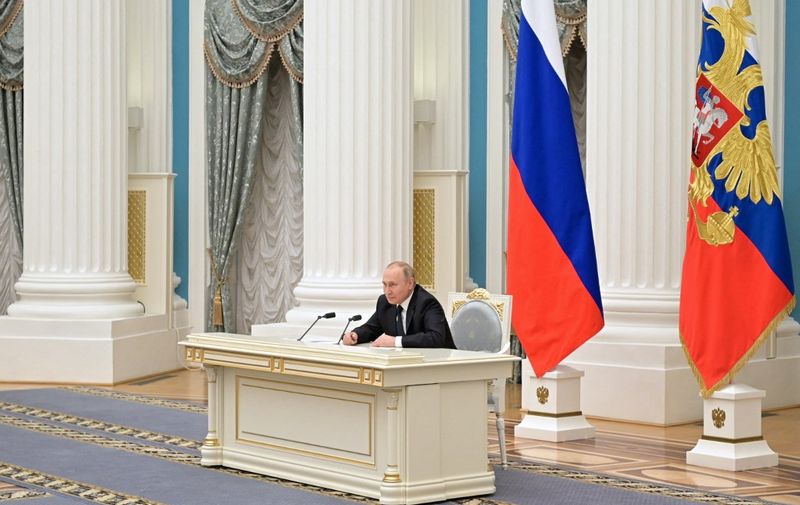 Russian President Vladimir Putin chairs a meeting of big businesses at the Kremlin in Moscow on February 24, 2022. - Russian President Vladimir Putin on Thursday said his country wanted to remain part of the world economy and had no plans to harm it. Russian President Vladimir Putin launched a full-scale invasion of Ukraine on Thursday, killing dozens and triggering warnings from Western leaders of unprecedented sanctions. Russian air strikes hit military installations across the country and ground forces moved in from the north, south and east, forcing many Ukrainians flee their homes to the sounds of bombing. (Photo by Alexey NIKOLSKY / SPUTNIK / AFP)